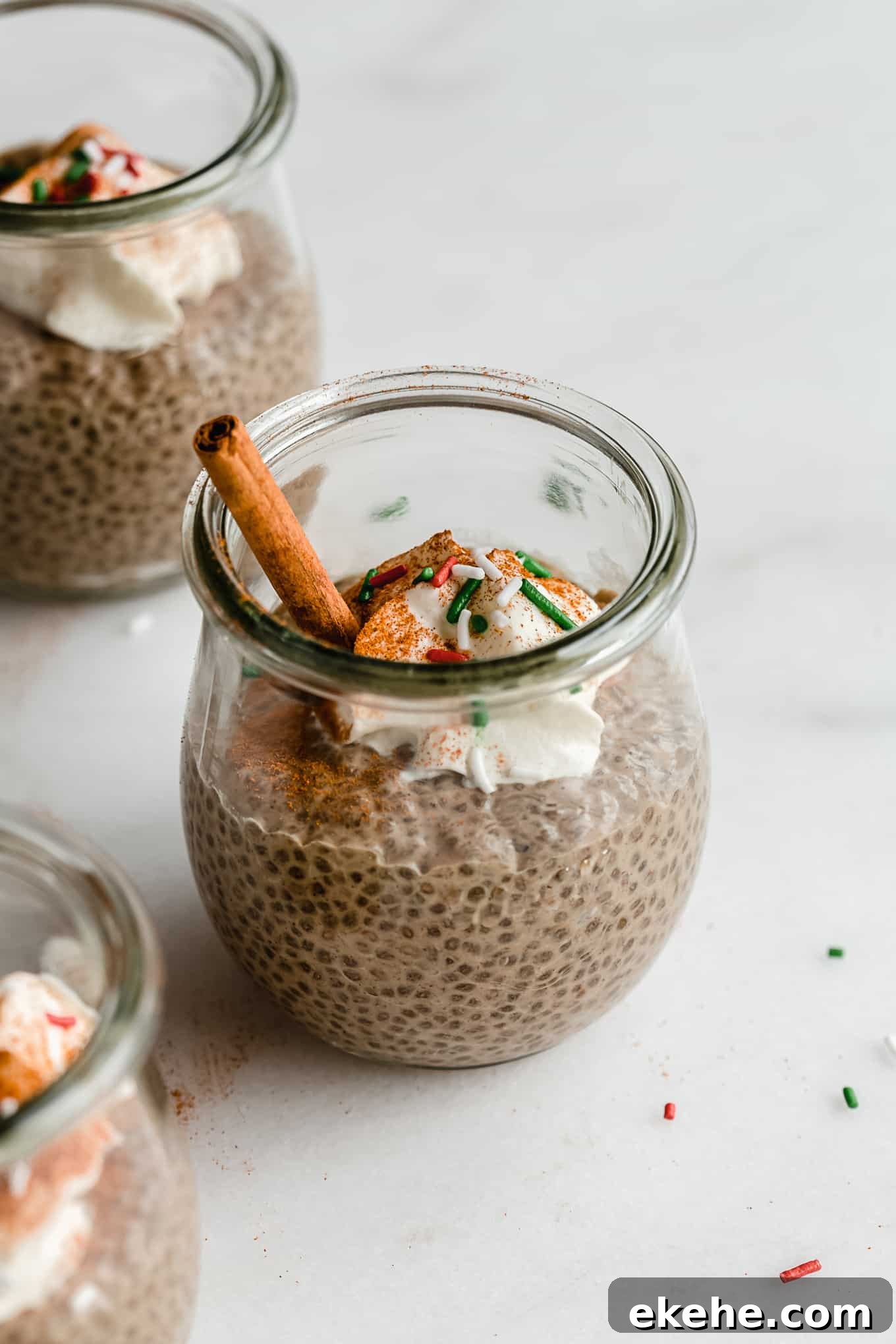 a jar of gingerbread chia pudding with red and green sprinkles