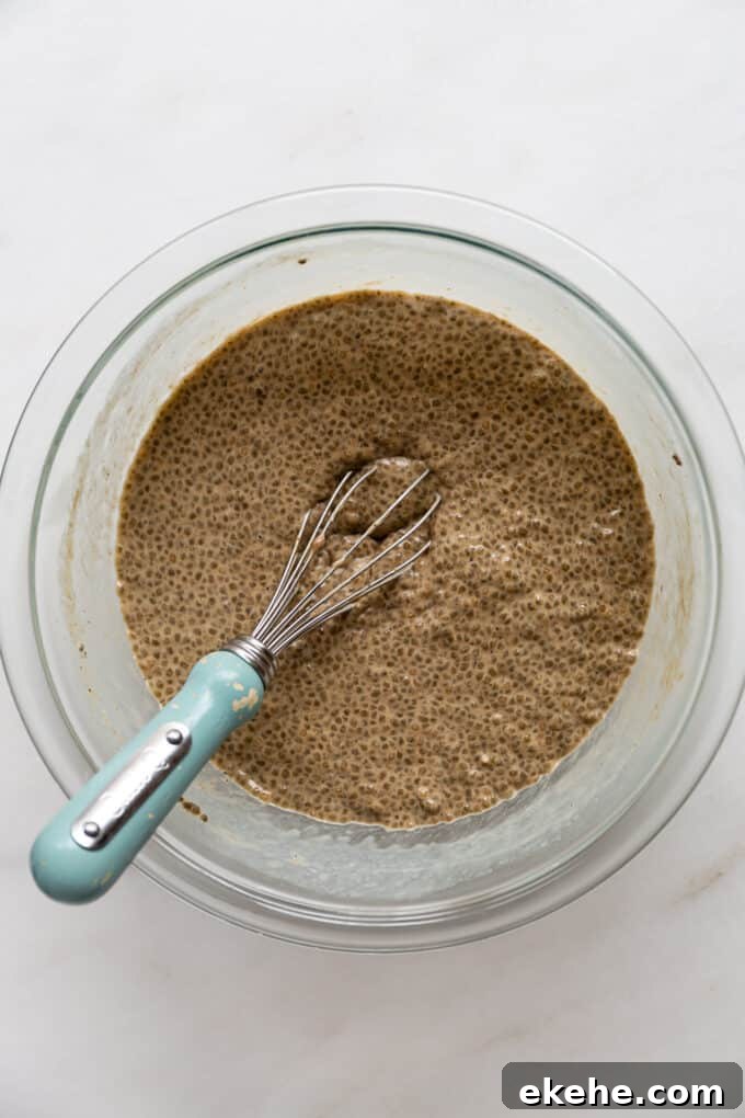 gingerbread chia pudding in a mixing bowl with a whisk