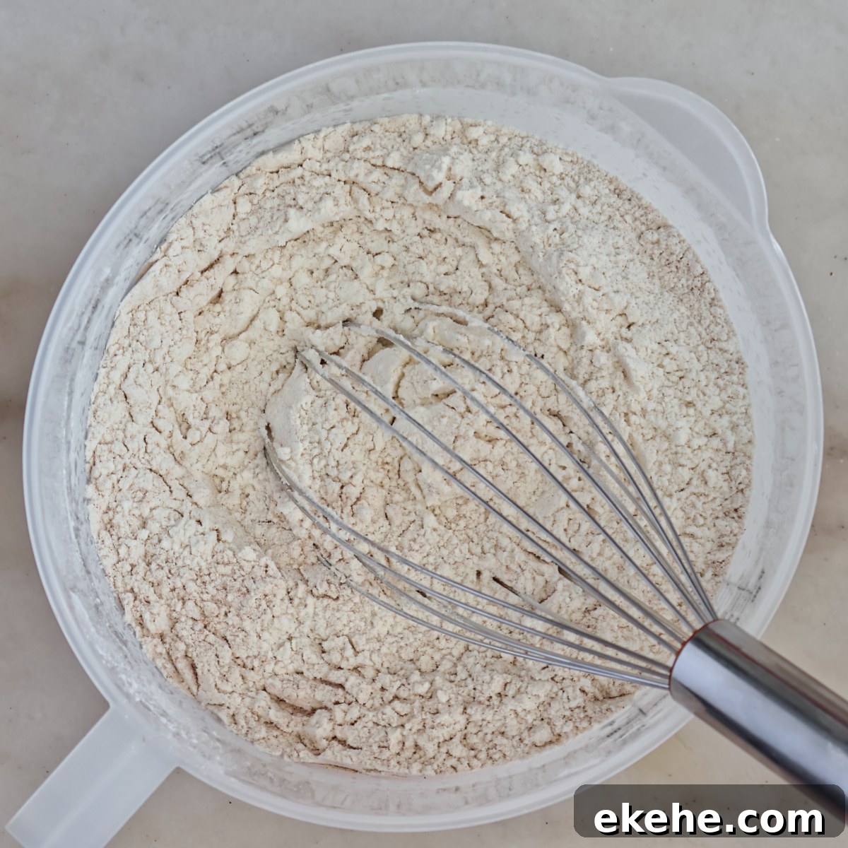 flour mixture in plastic jug with whisk.