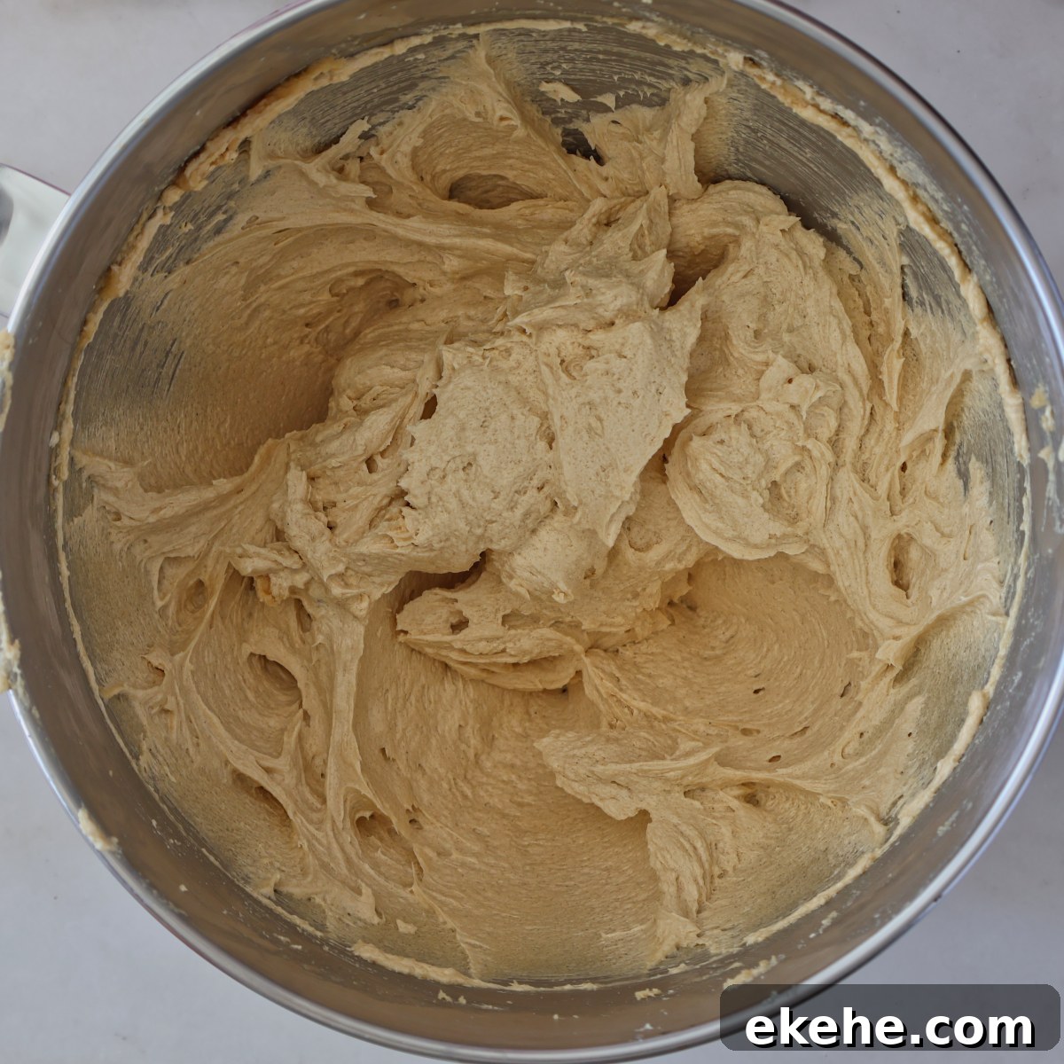light brown cookie dough in stainless steel bowl.