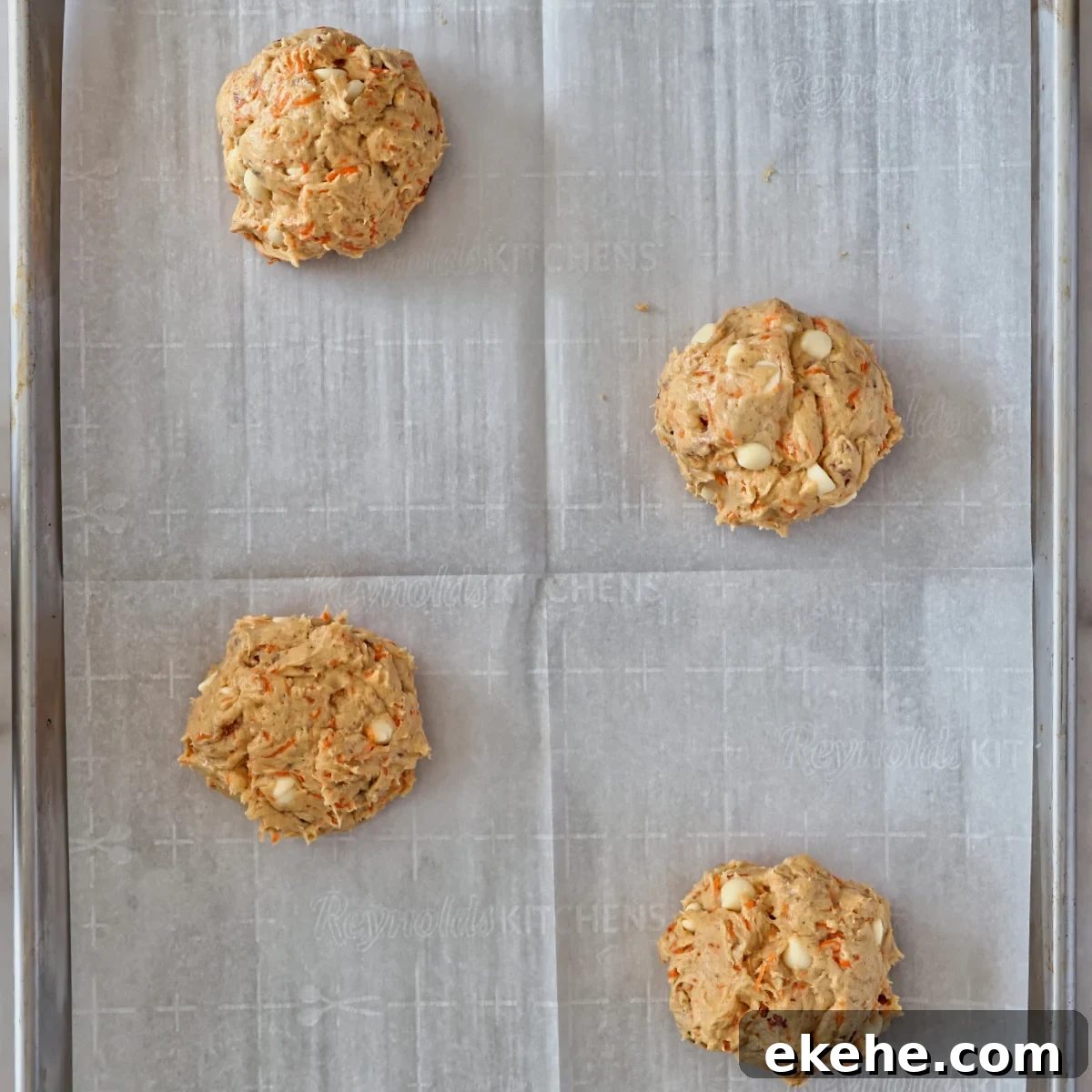 cookie dough balls on parchment paper. 