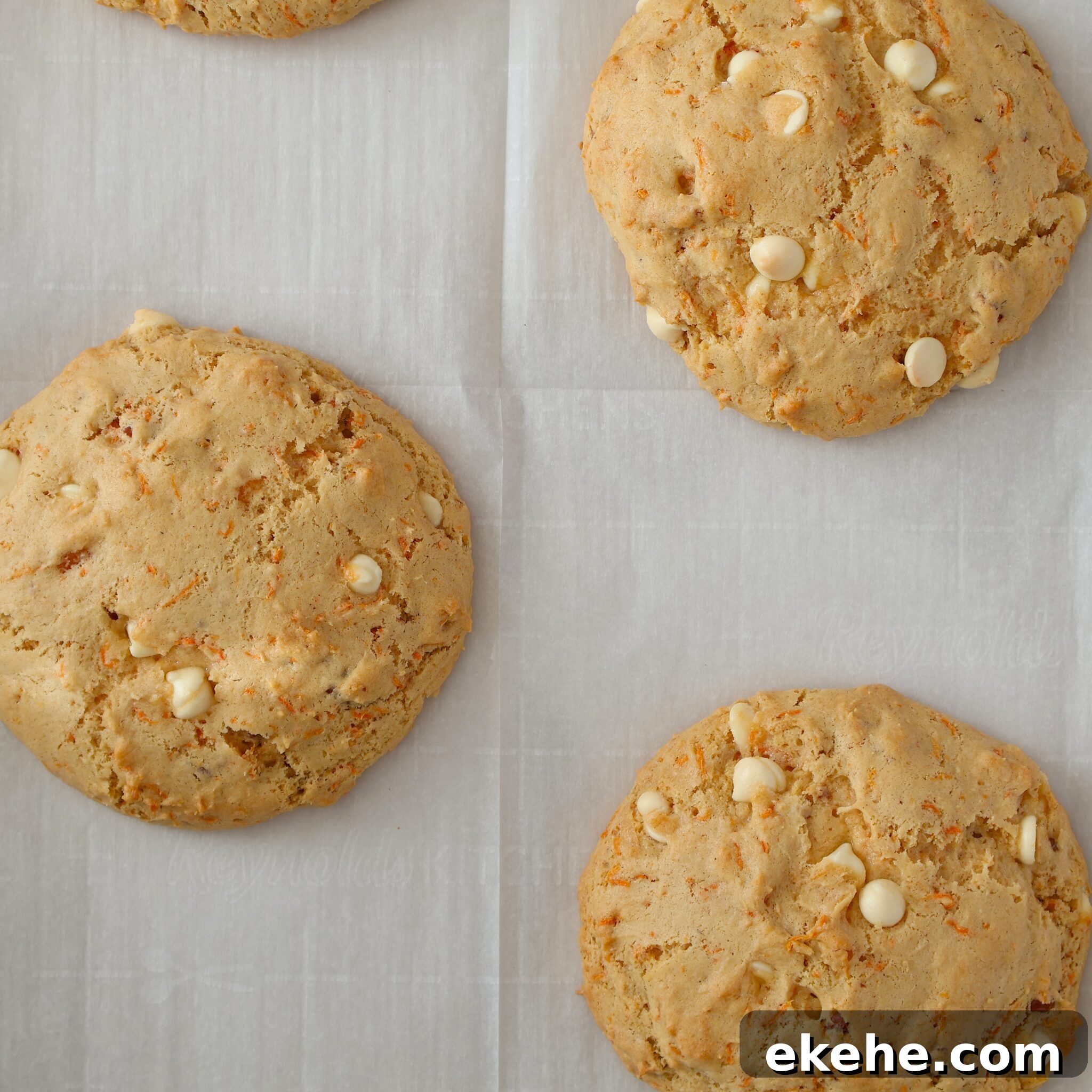 baked light brown cookies on parchment paper.