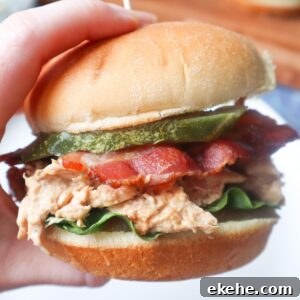 chicken bacon ranch sandwich with ranch shredded chicken, lettuce, bacon, and pickle