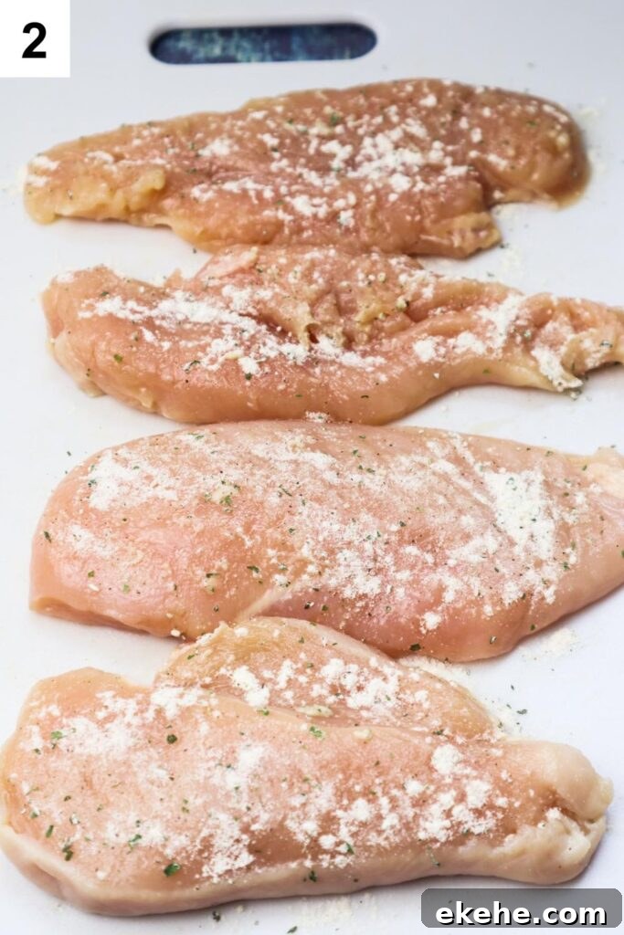 cutting board with chicken breasts seasoned with ranch seasoning