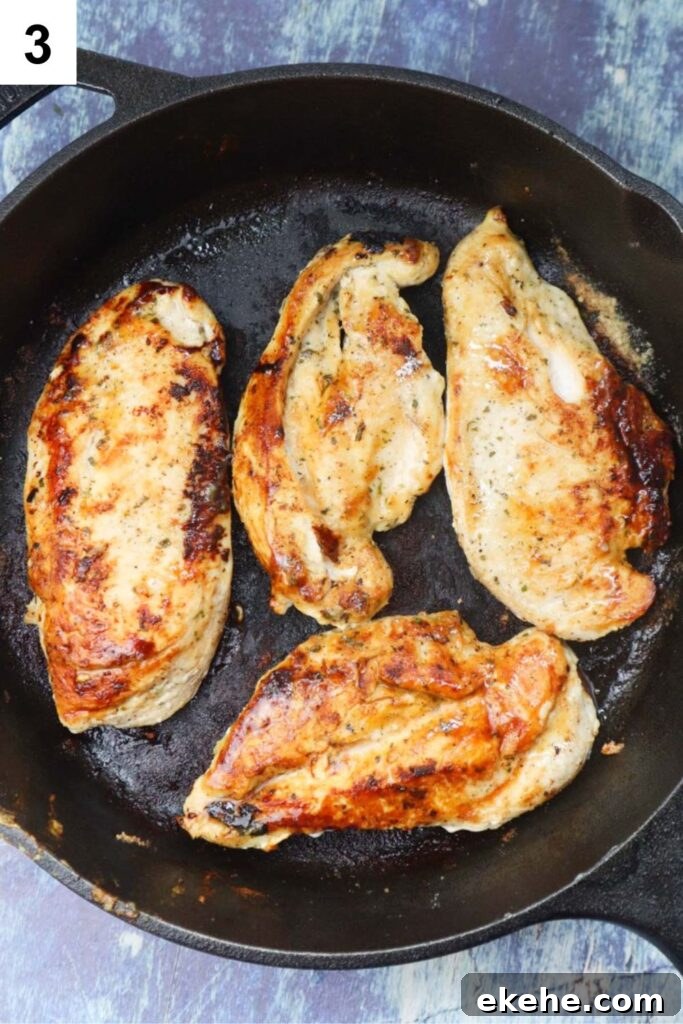 cast iron skillet with cooked chicken breasts