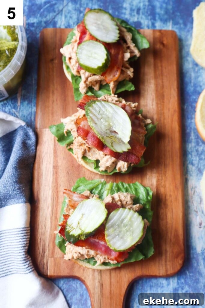 cutting board with assembled sandwiches without tops