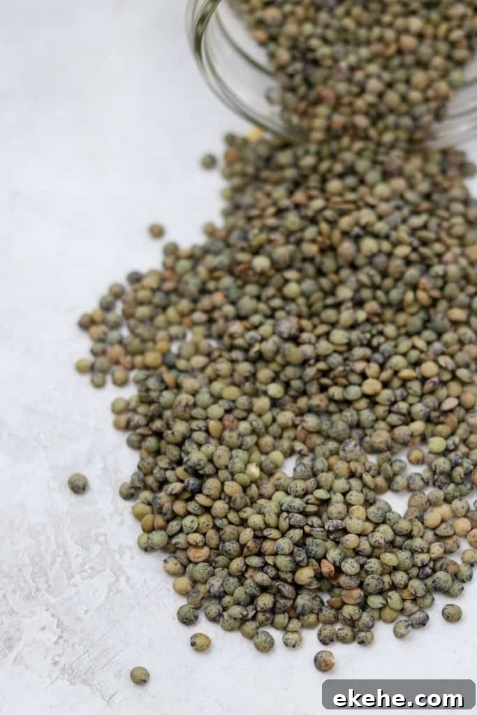 Jar of lentils spilled onto a concrete surface