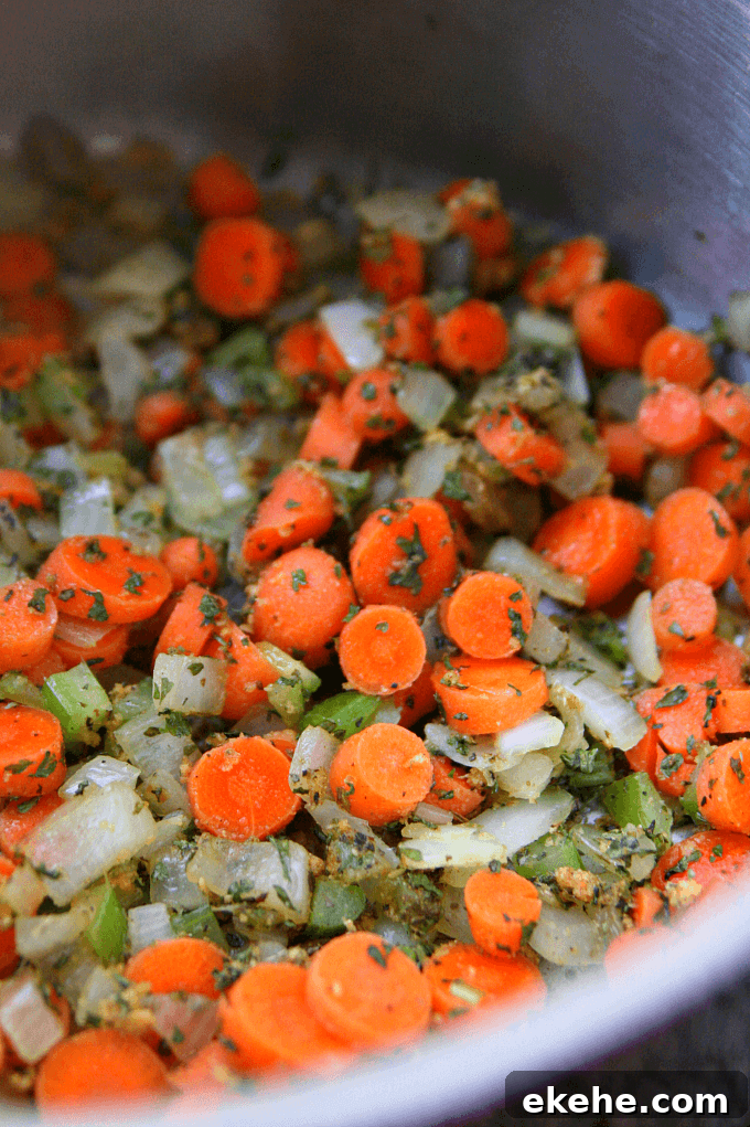 Vegetables being sautéed in a saucepan.