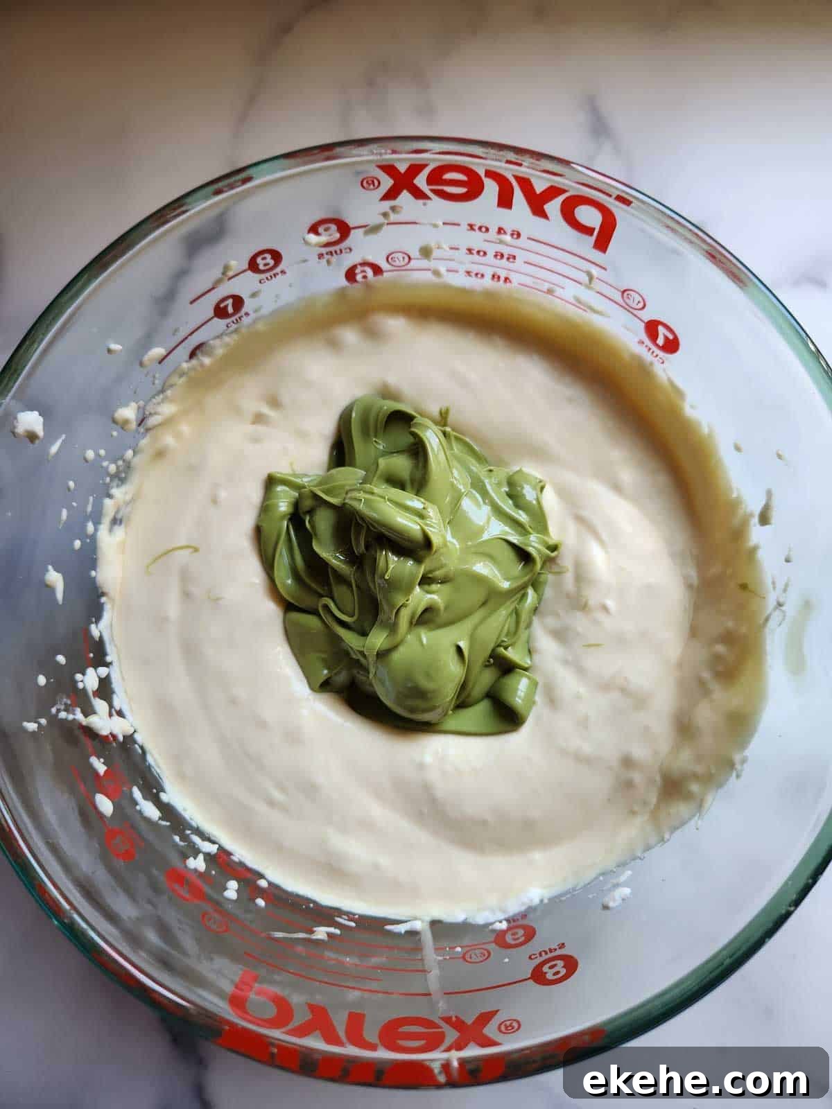 Pistachio paste and whipped cream in a bowl.