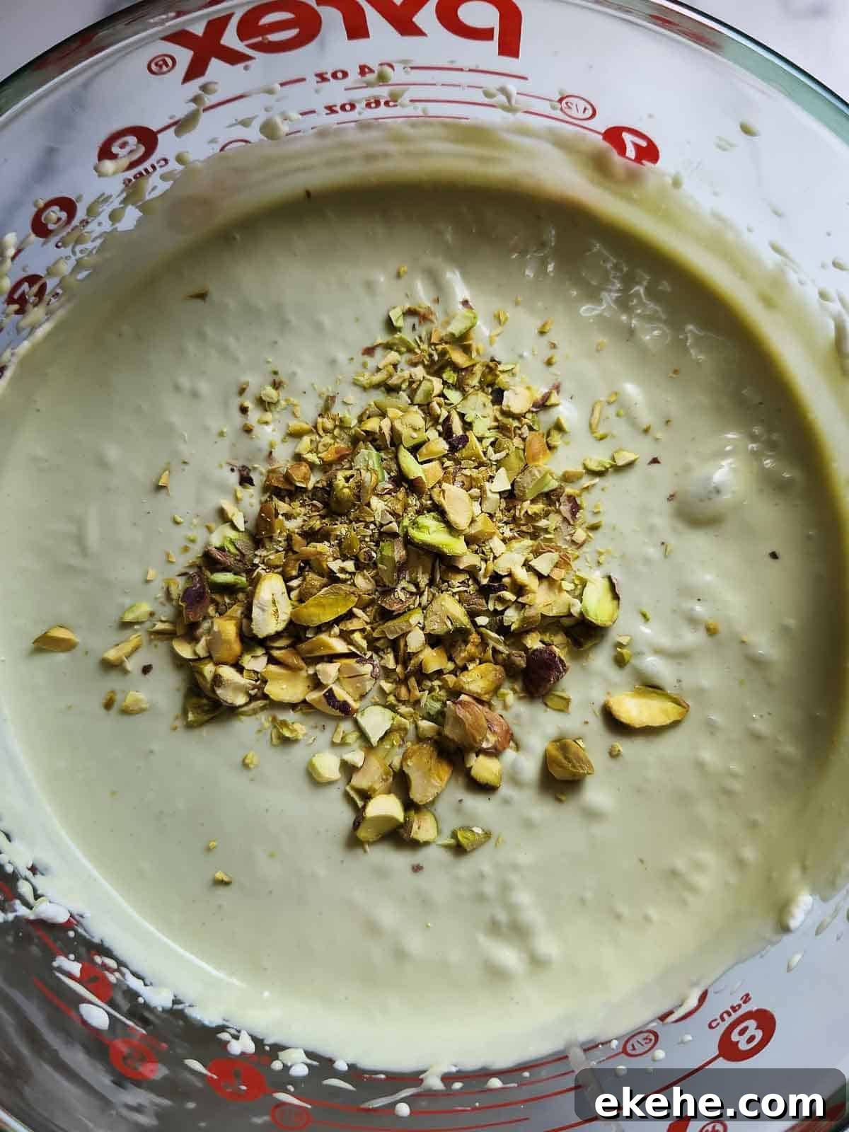 Mixed pistachio ice cream base for home made ice cream in a bowl.