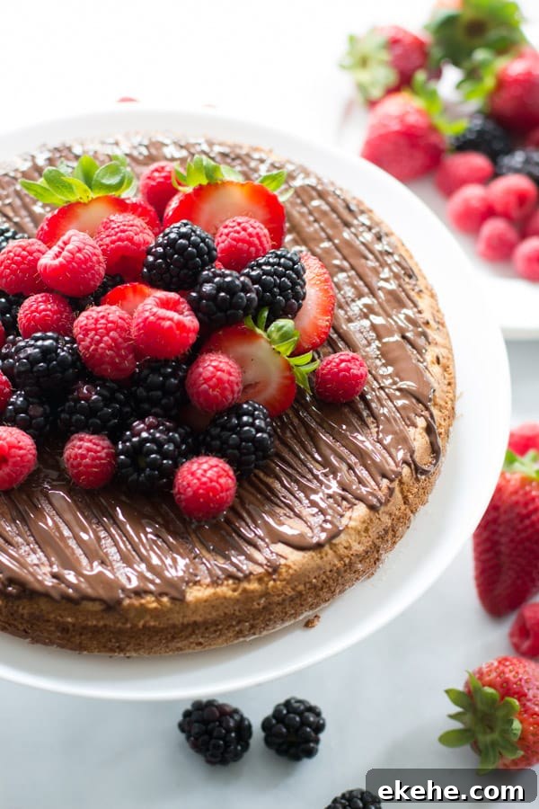 Close up of an almond cake with berries.
