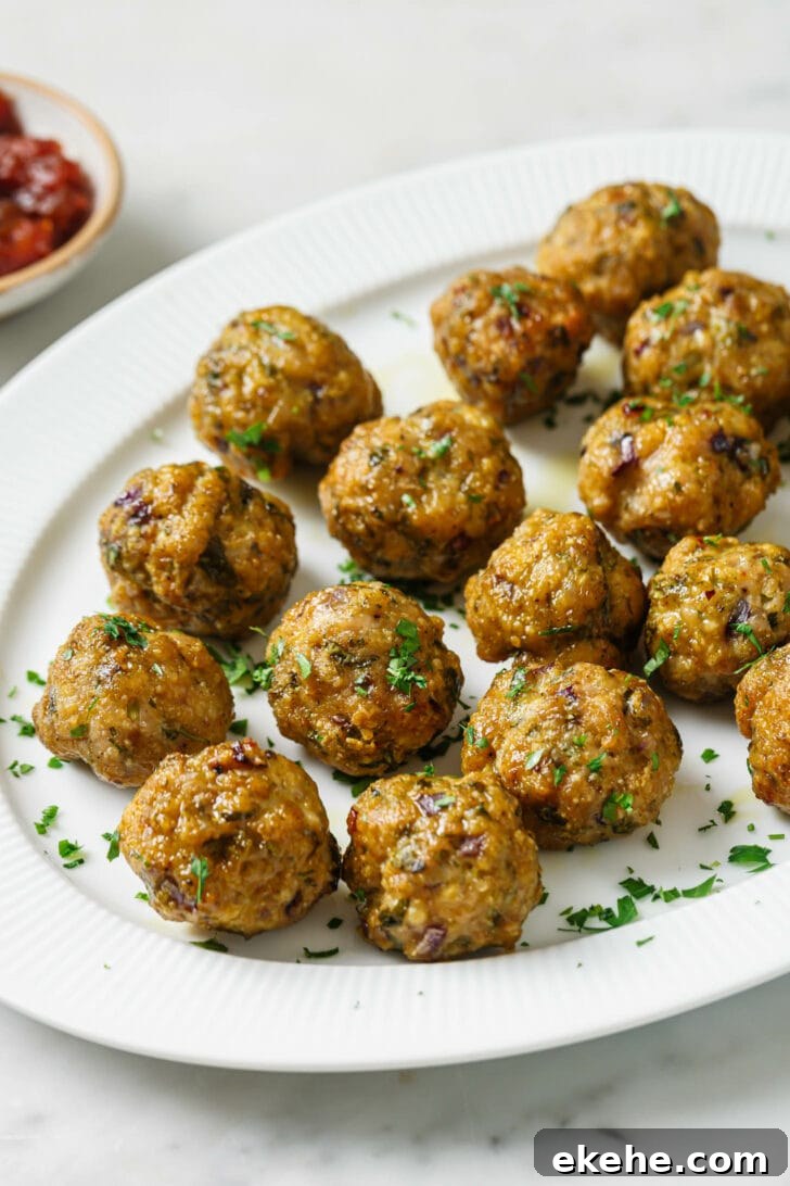 A platter with Baked Chicken Kofta garnished with chopped cilantro.