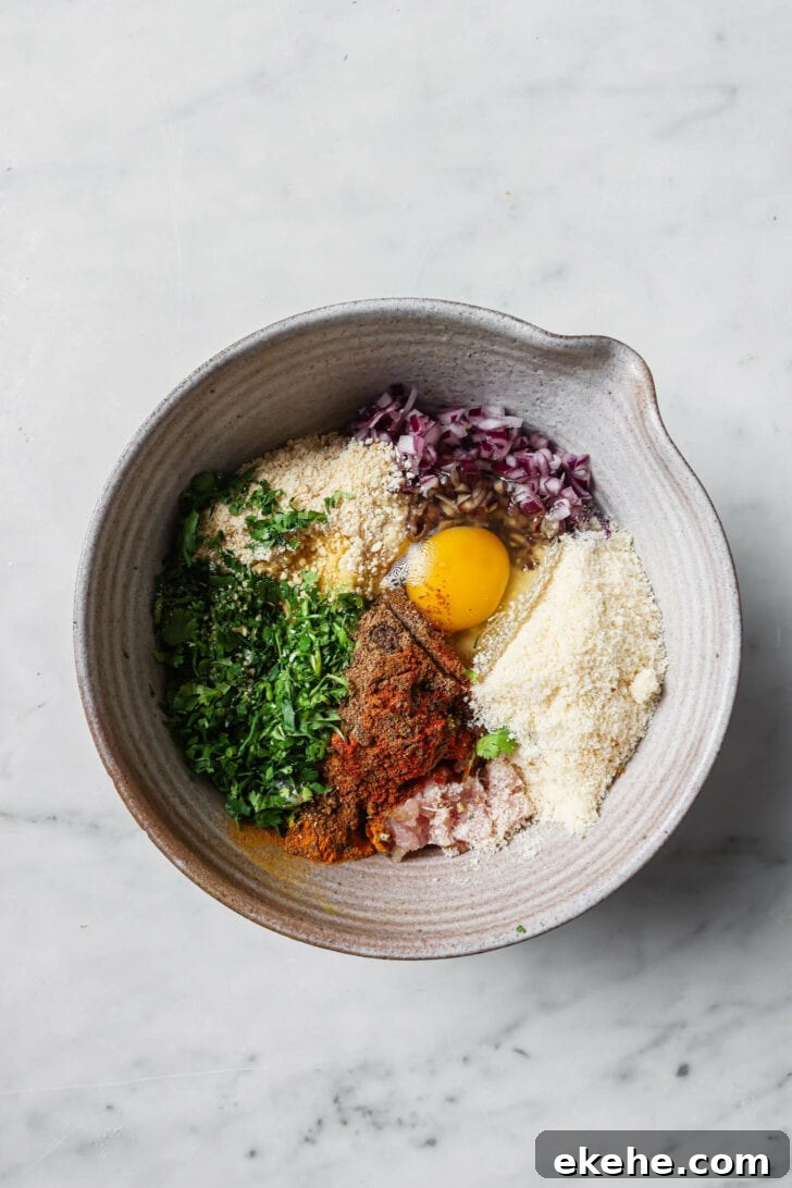 Ingredients to make Baked Chicken Kofta in a bowl ready to be mixed.