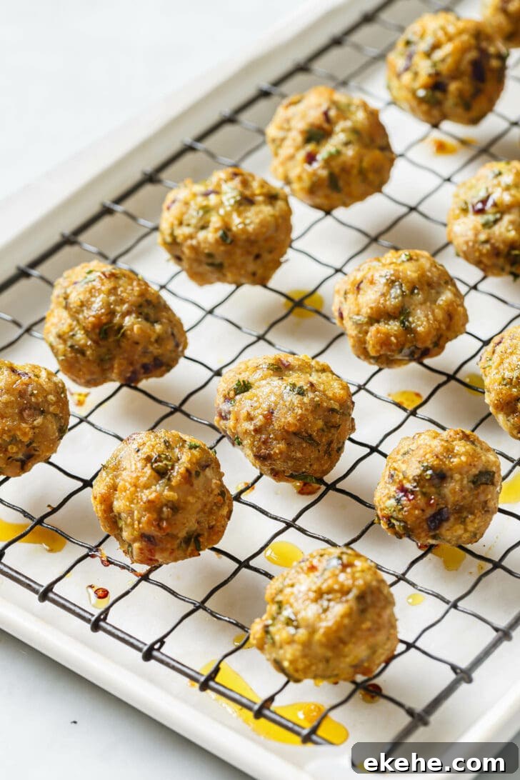 Baked Chicken Kofta on a rack atop a parchment lined baking sheet.