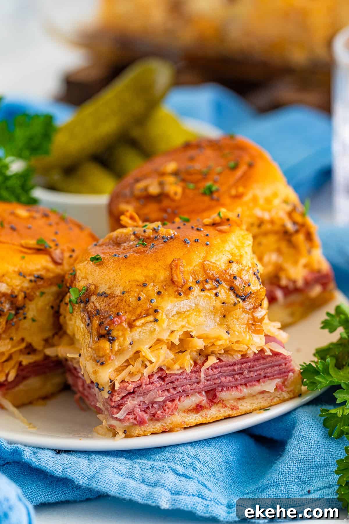 Three Reuben Sliders on white plate.