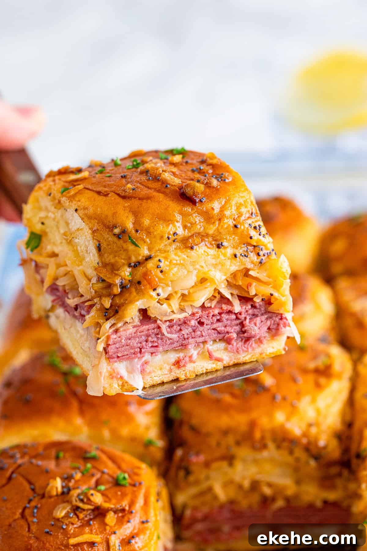Spatula holding up one Reuben Slider.