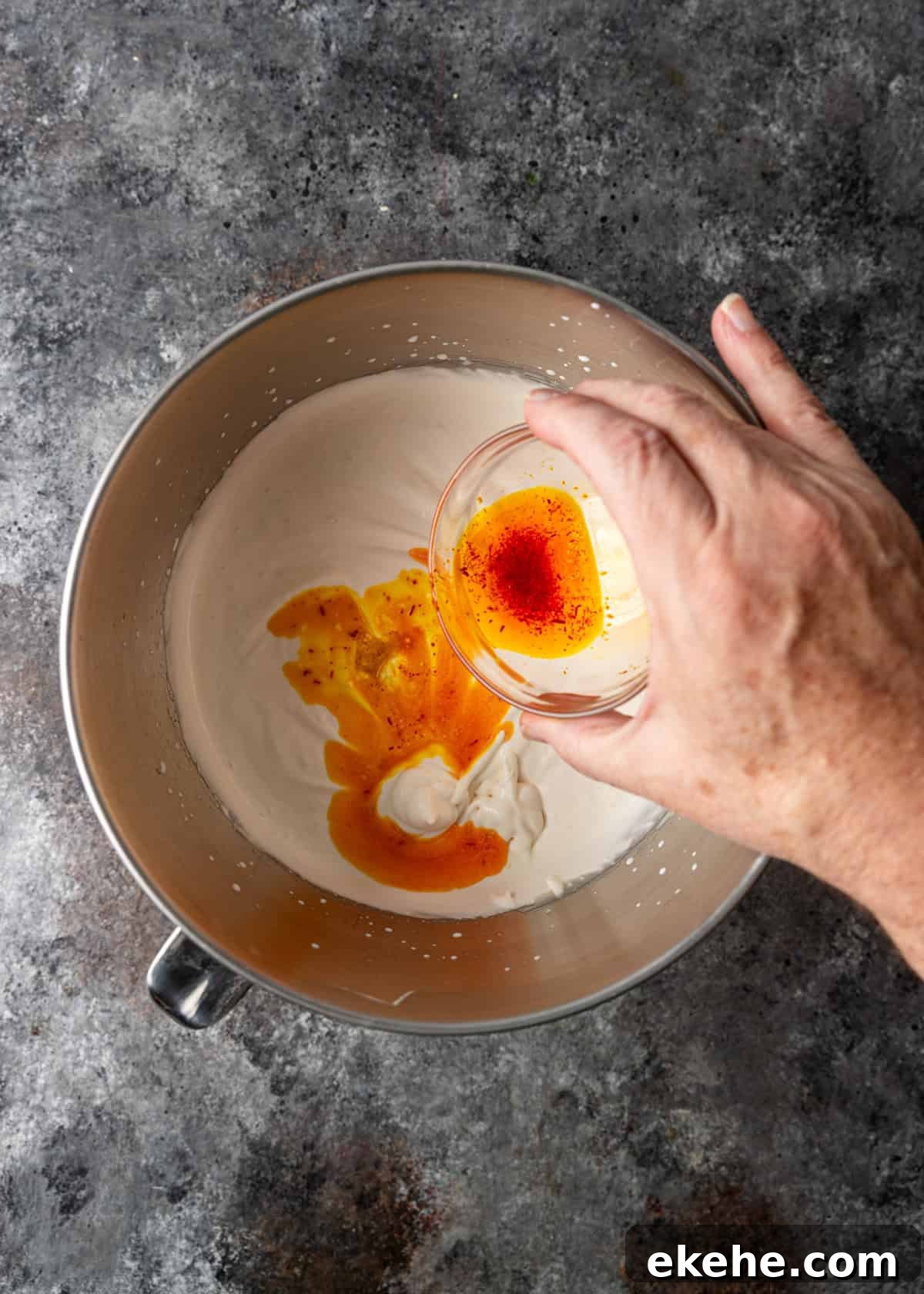overhead process shot: adding the saffron and rose water mixture to cream and milk