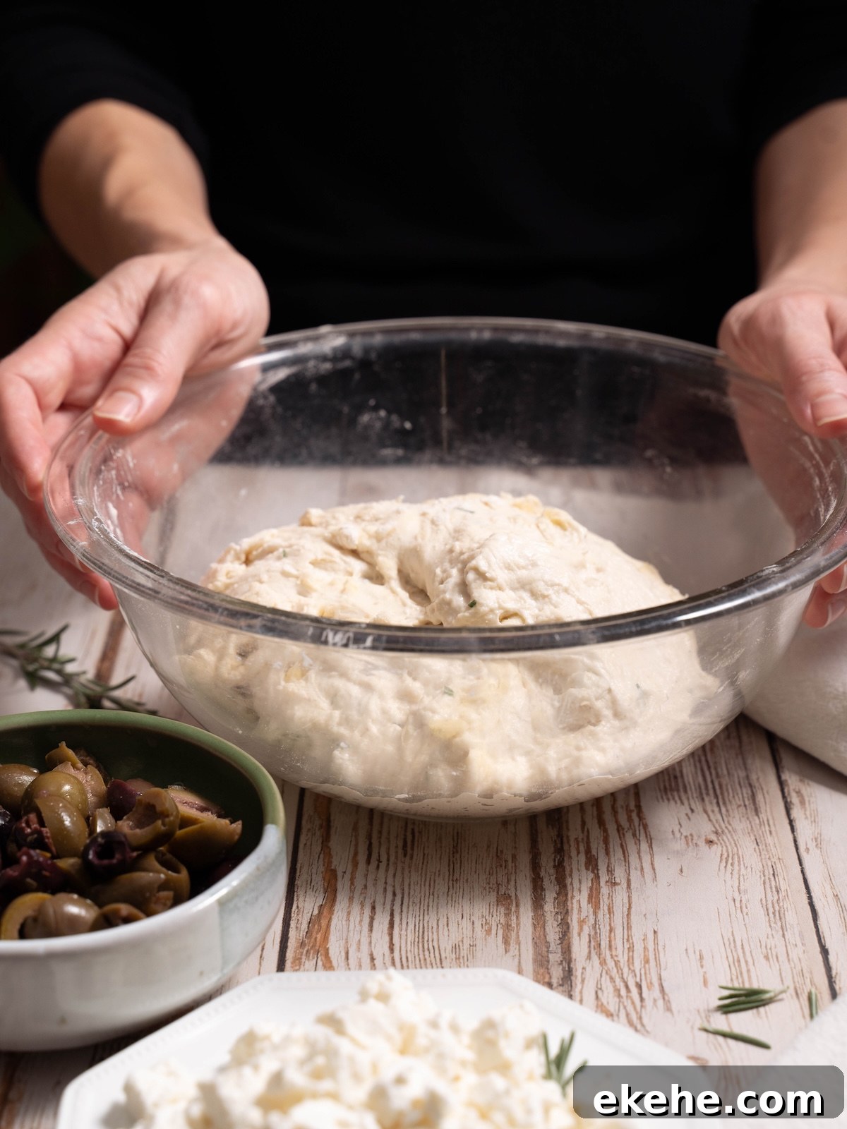 A bowl of sourdough, olives, and feta