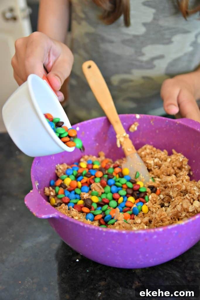 adding m&ms to Monster Cookie Energy Balls