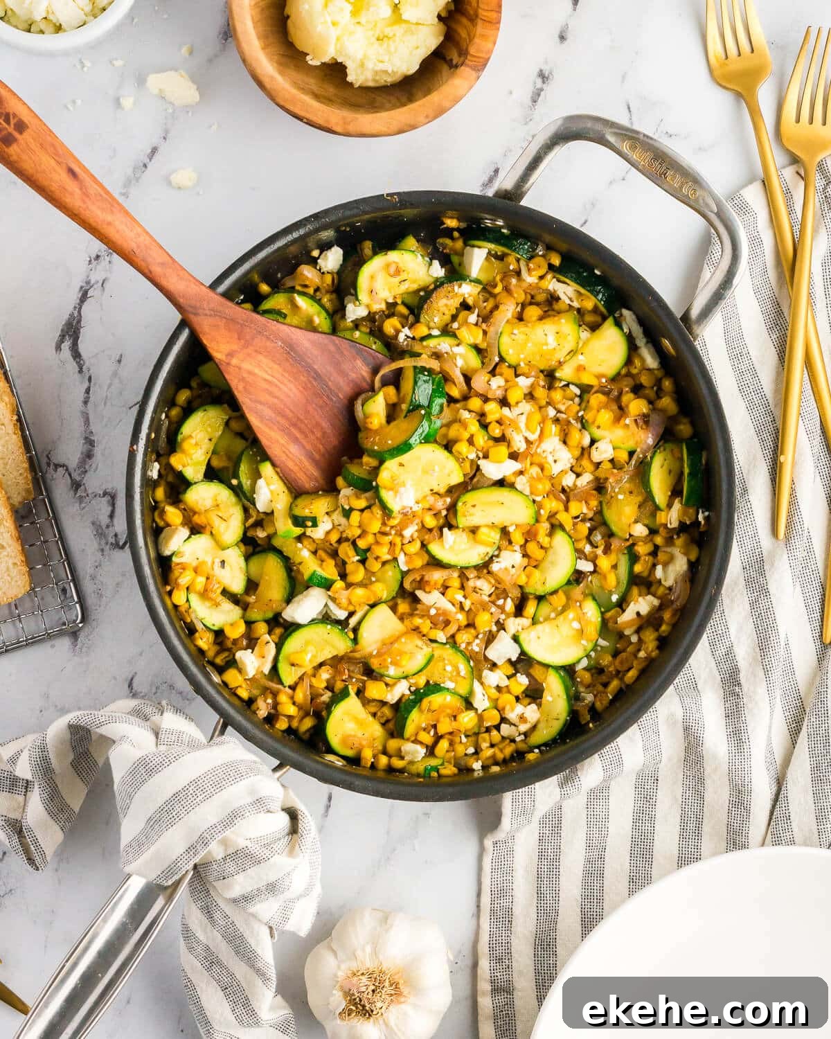 sauteed zucchini, corn, and feta in a skillet.