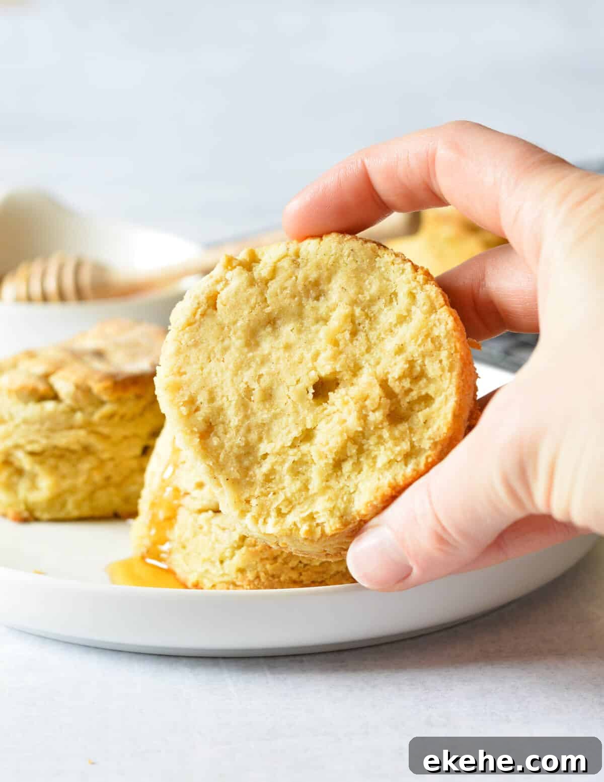 hand holding half of a gluten free biscuit. 