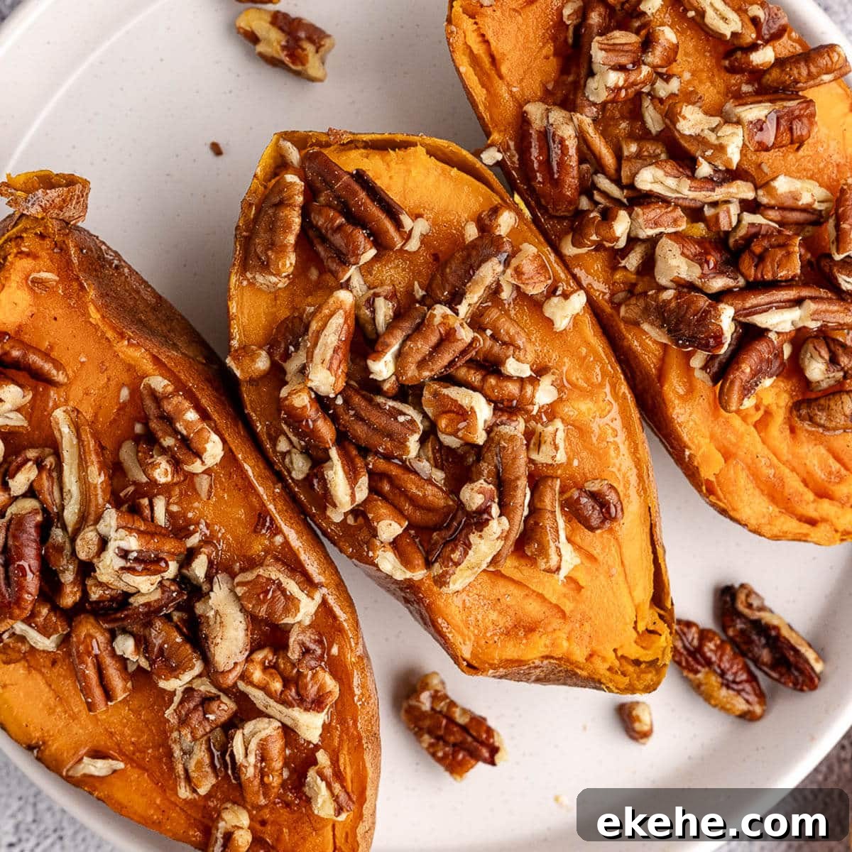 baked sweet potatoes with pecans on top.