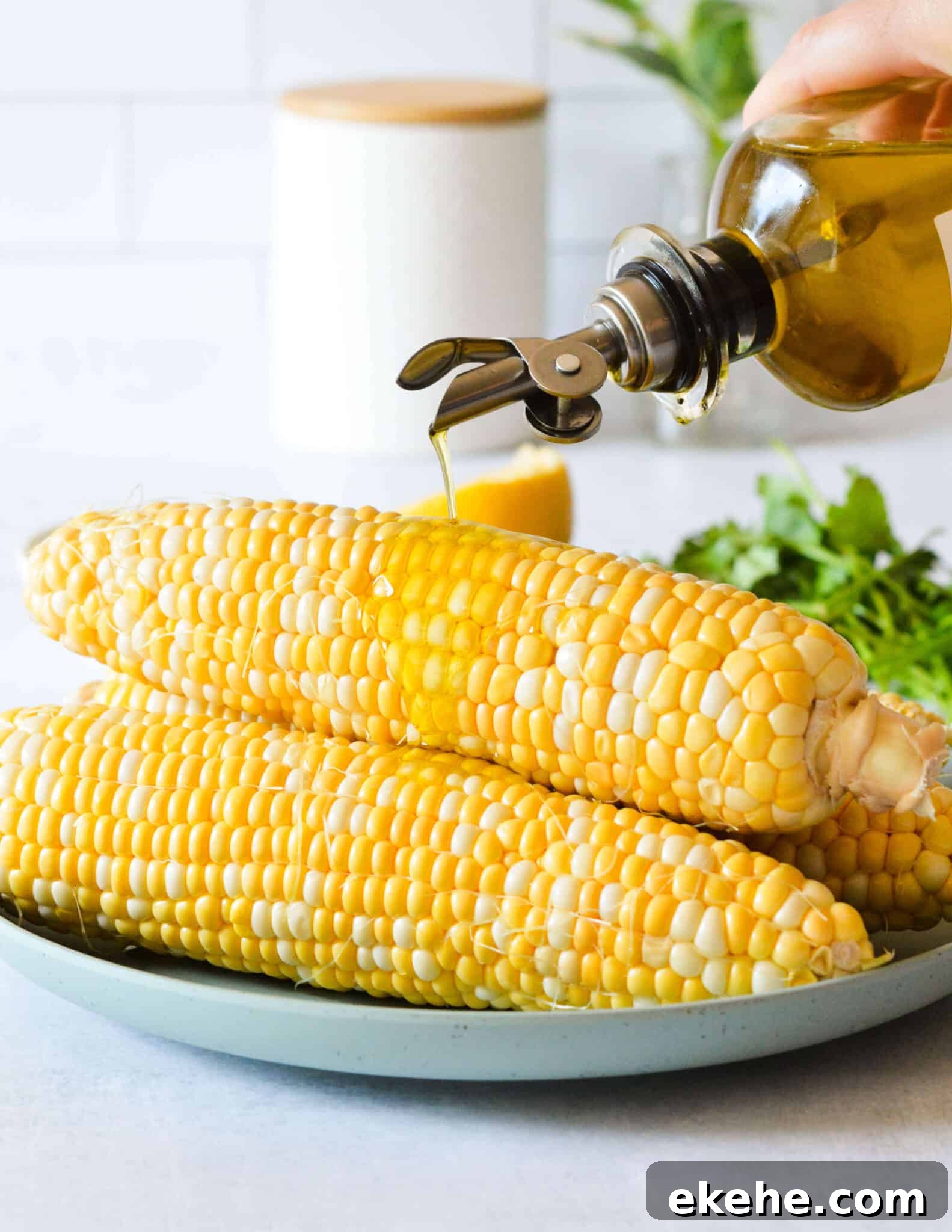 drizzling olive oil onto a plate of corn 