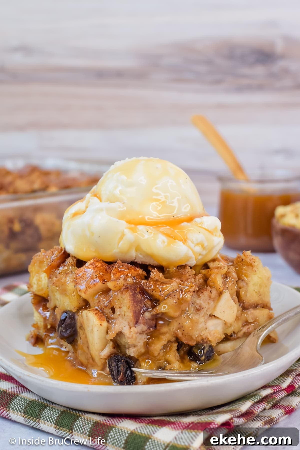 A square of apple dessert casserole topped with ice cream and caramel.