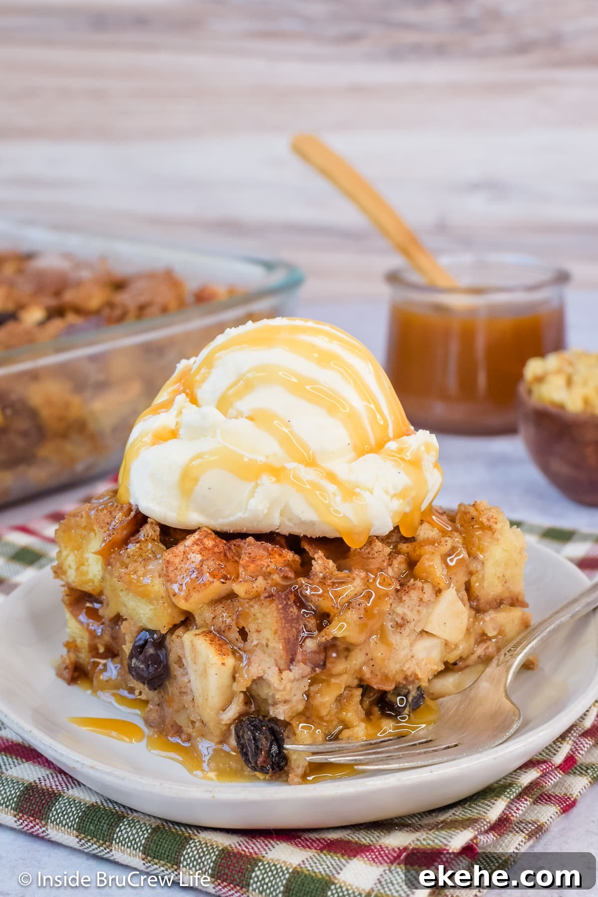 Apple bread casserole topped with ice cream and caramel.