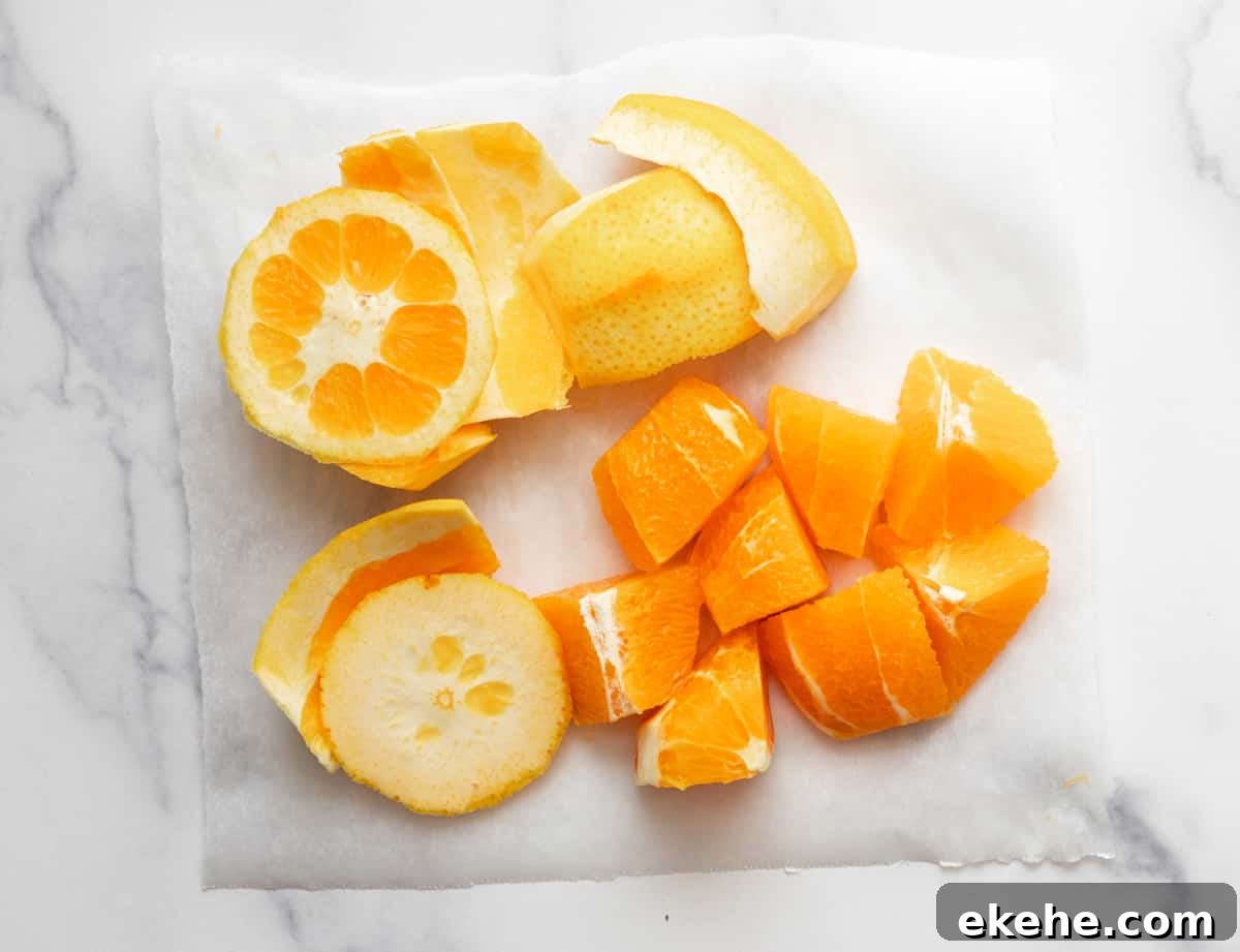 chopped orange peel and pith removed on a cutting board.