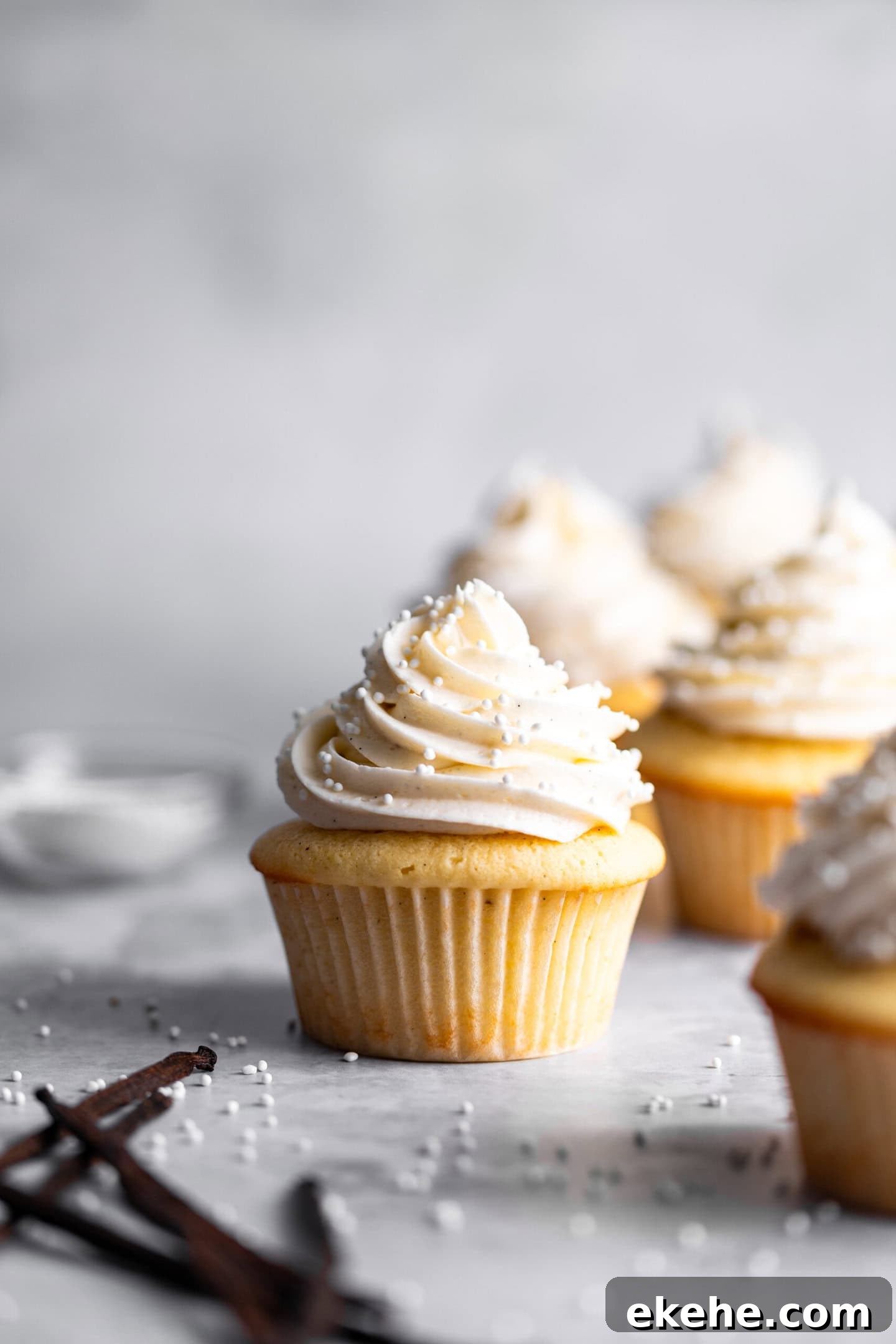 Small Batch Vanilla Cupcakes with vanilla bean buttercream and sprinkles on top.