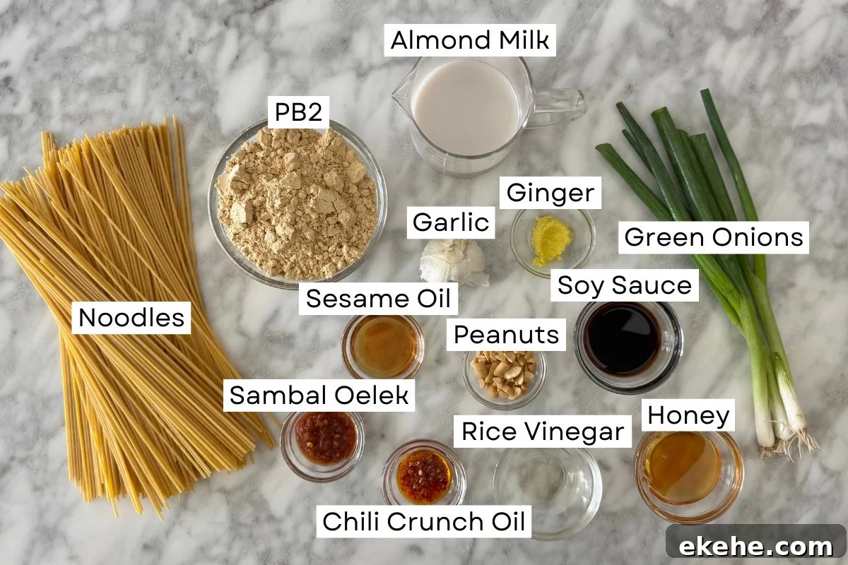 Ingredients for healthy spicy peanut noodles in bowls.