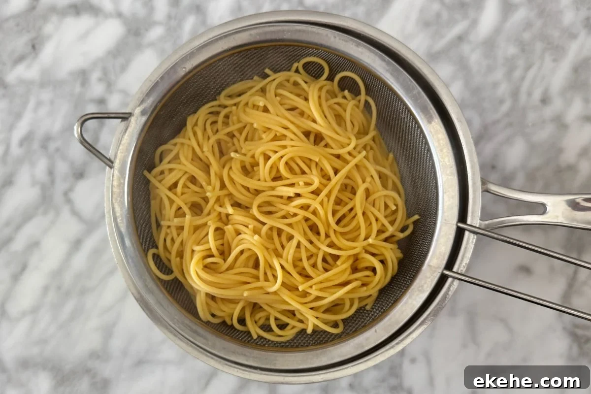 Cooked high fiber high protein noodles in a strainer.