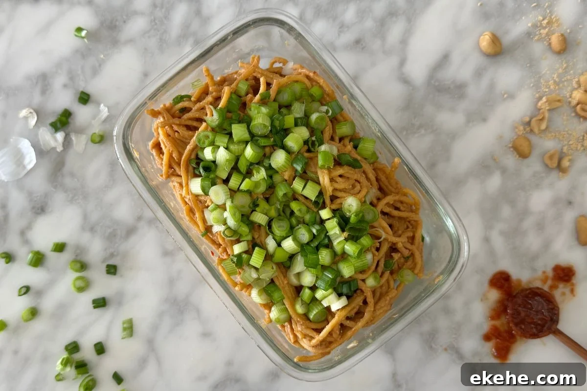 Healthy spicy peanut noodles in a storage container.