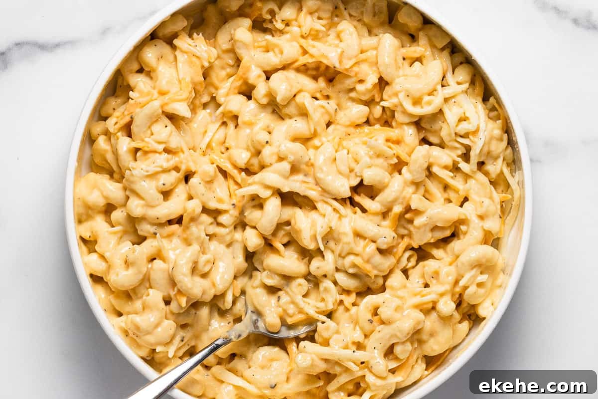 White bowl filled with mac and cheese pizza topping