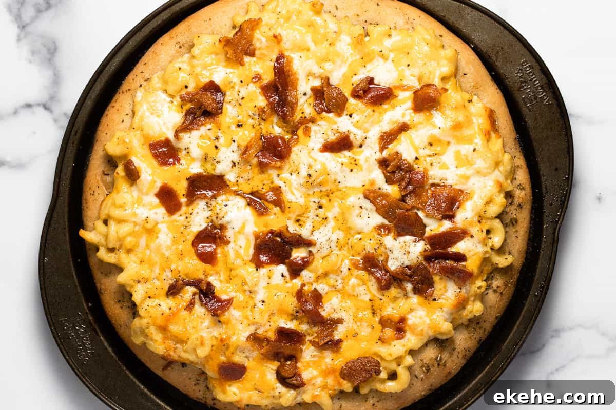 Freshly baked mac and cheese pizza with crumbled bacon