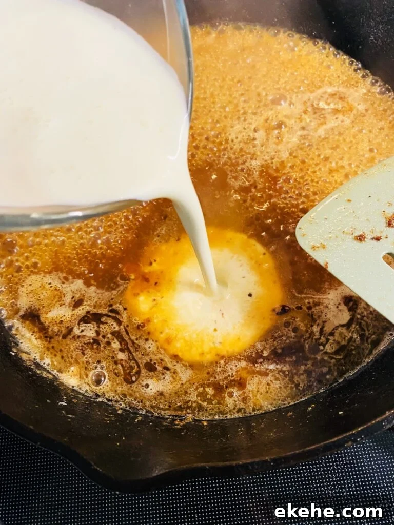 adding cream to skillet