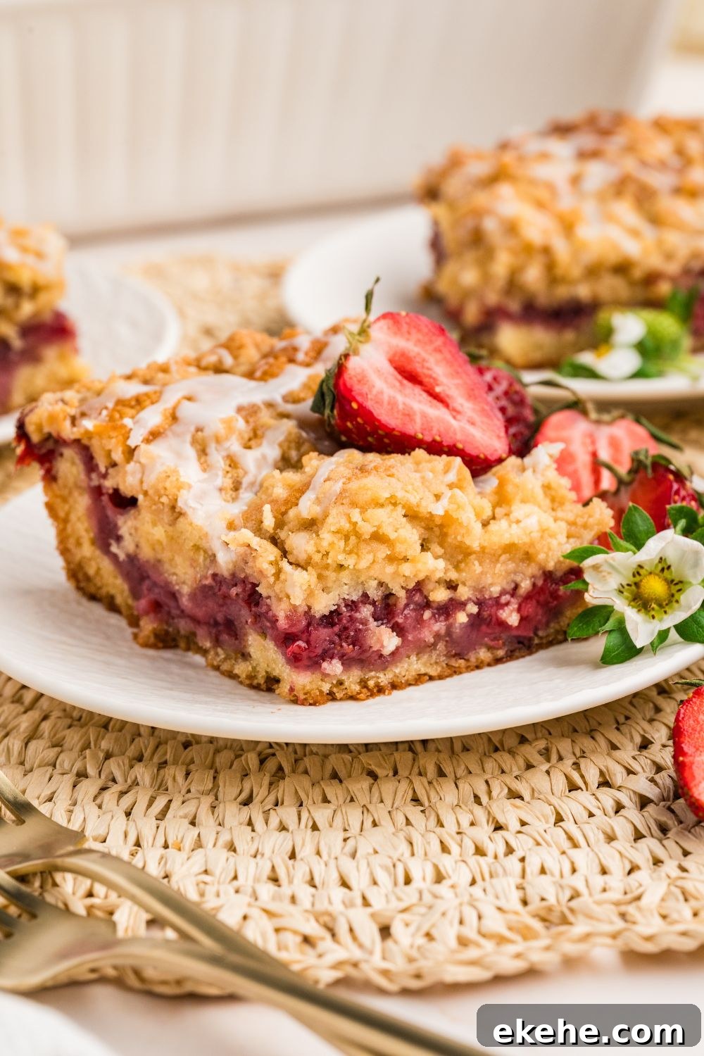 Strawberry Coffee Cake on plates with a fork and berries on top 