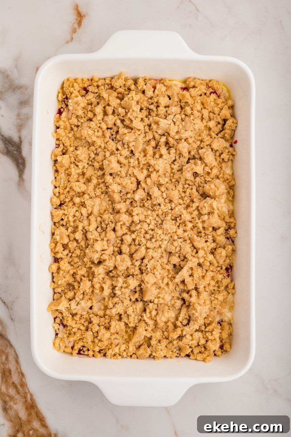 overhead shot of pan with crumble on top for the Strawberry Coffee Cake