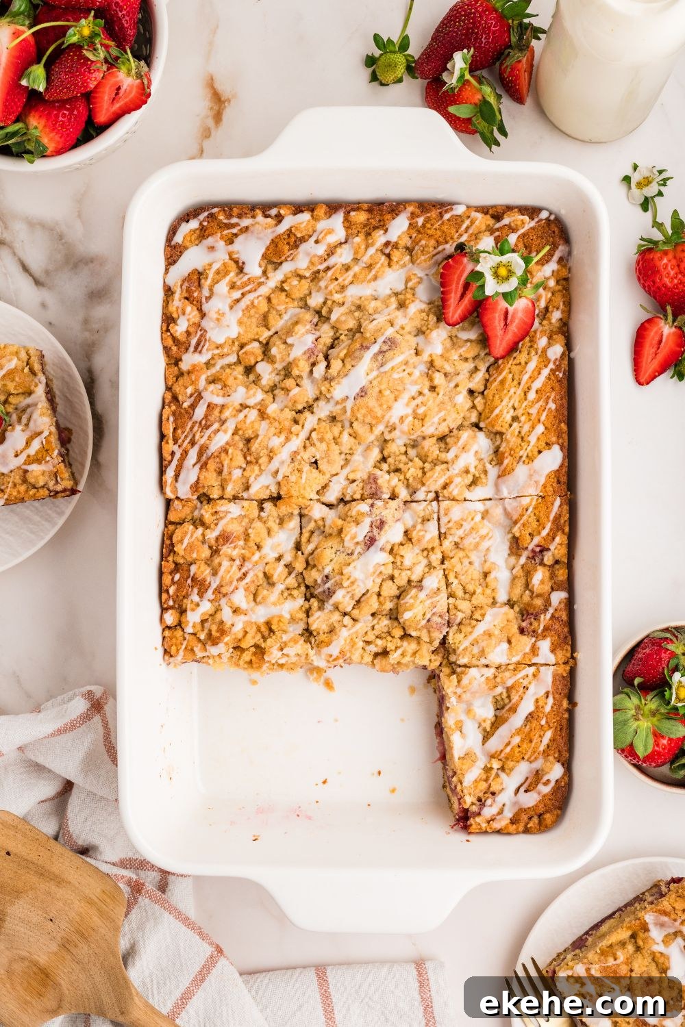 Strawberry Coffee Cake in pan with some slices cut out of it 