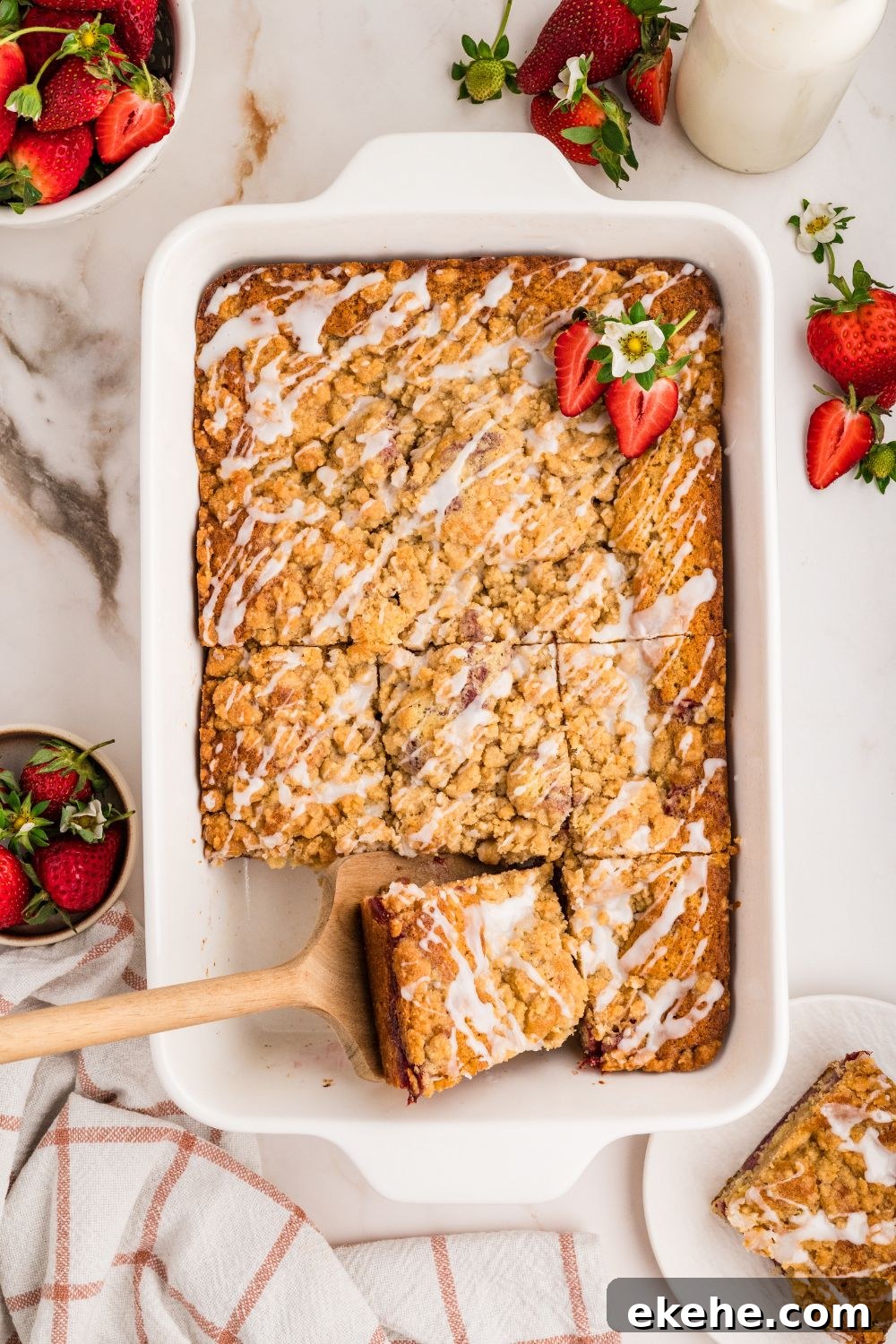 Strawberry Coffee Cake in pan with a slice taken out of it 