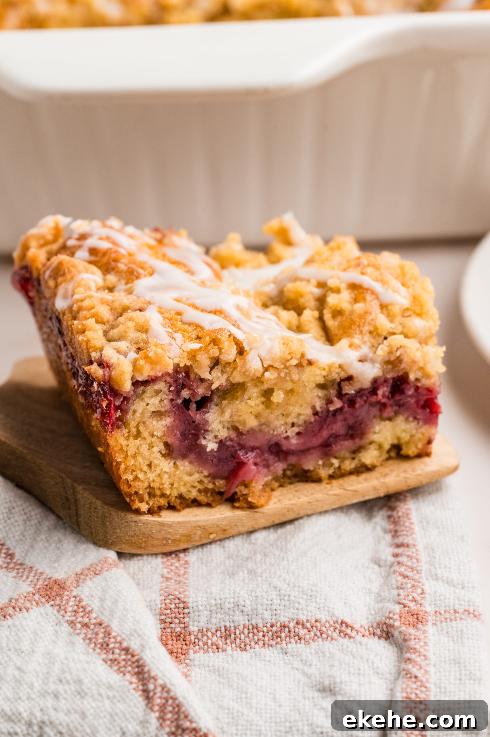 Strawberry Coffee Cake on a wooden spatula sitting on a table 