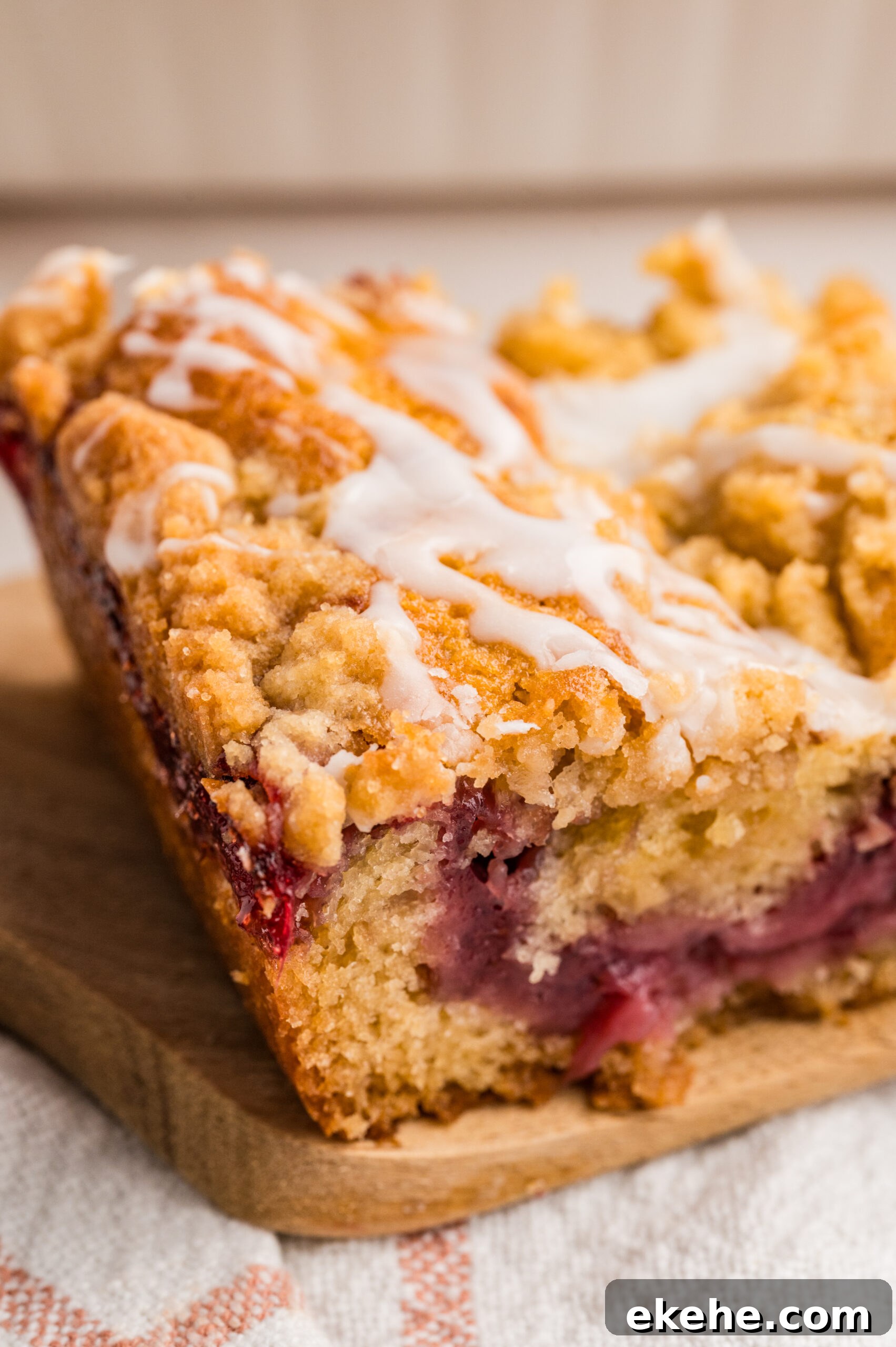 Strawberry Coffee Cake slice on a wooden cutting board