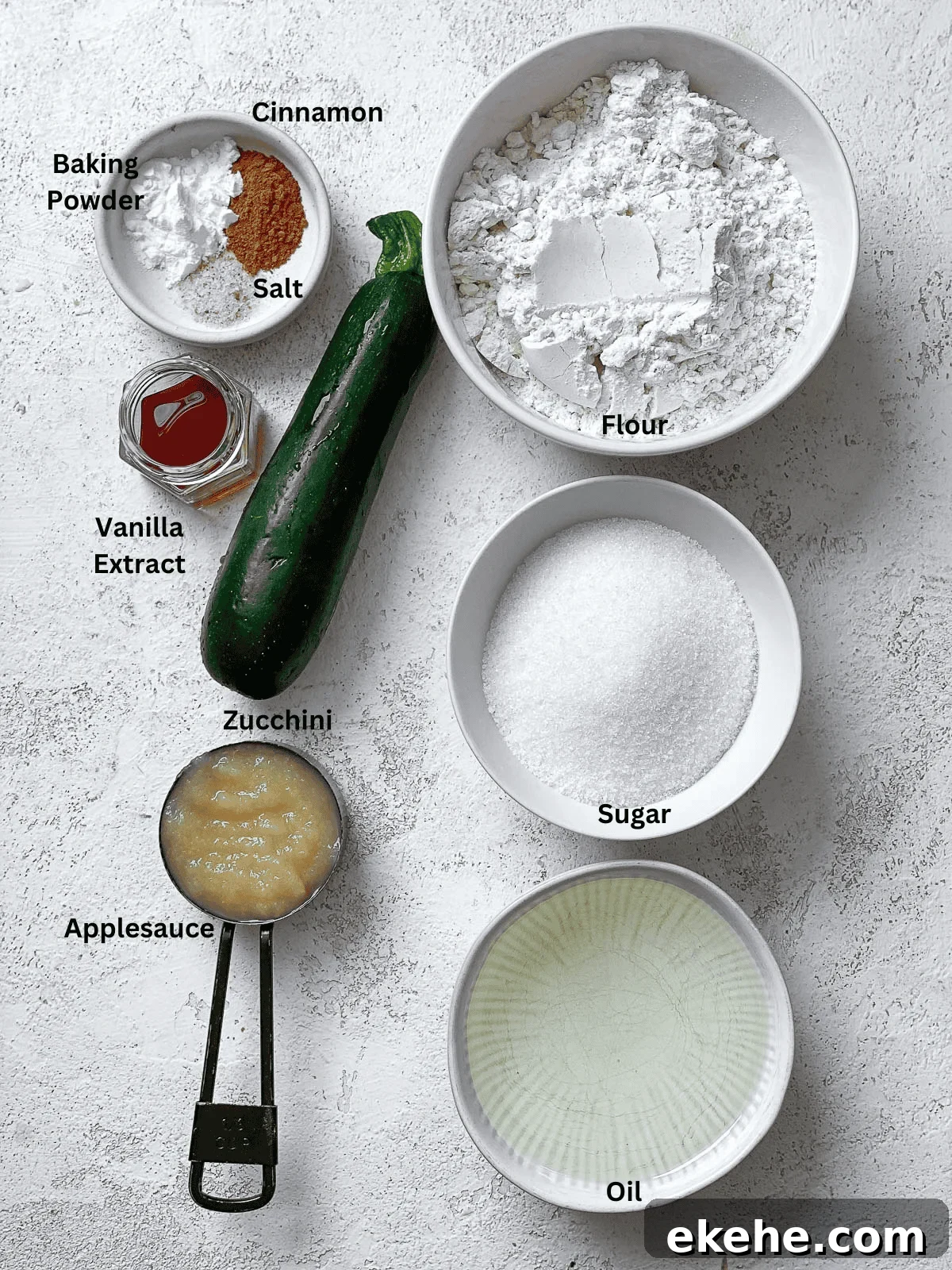 Ingredients for Easy Vegan Zucchini Bread measured out on a white surface. 