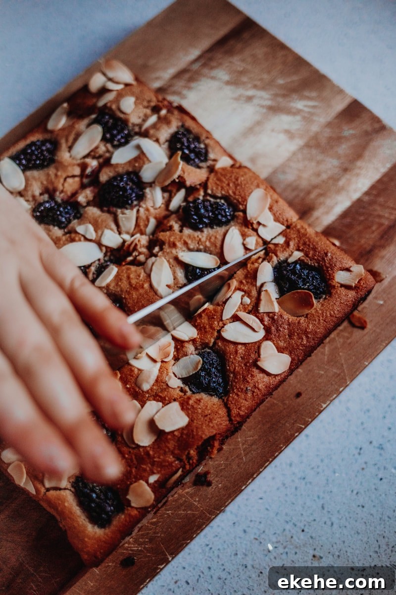 Chopping the Blackberry Bakewell Bars into slices