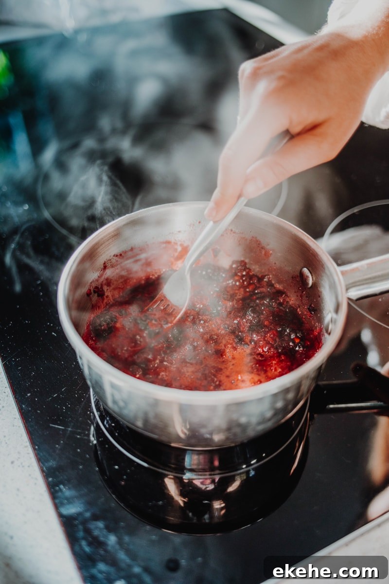 making the blackberry chia jam in a saucepan over the stove