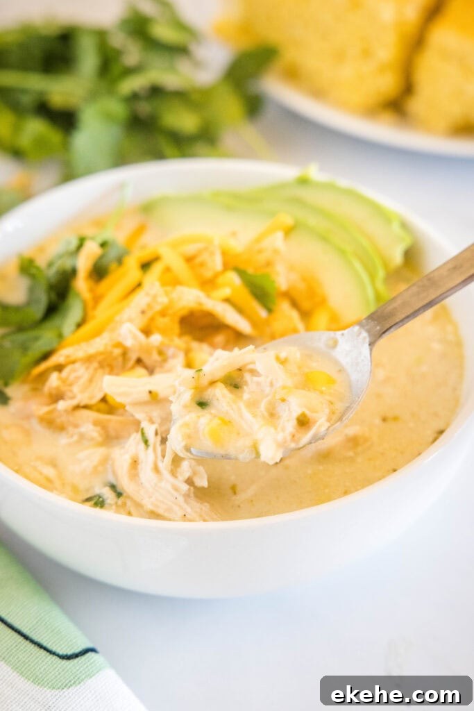 a spoonful of white chicken chili over a bowl