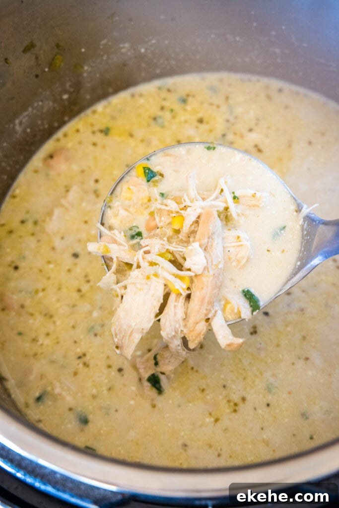 a ladle of white chicken chili over instant pot
