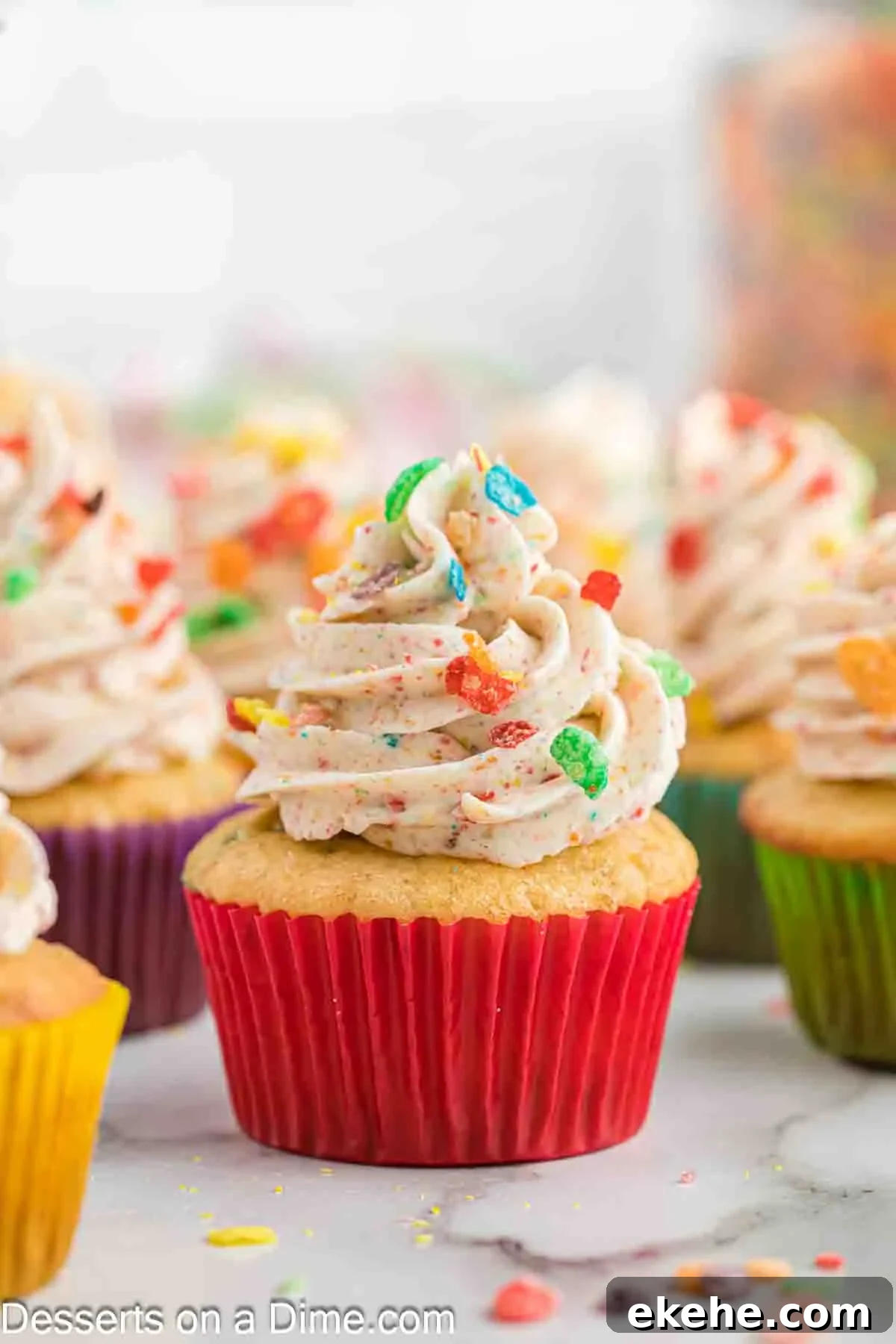 Fruity pebbles cupcakes on a platter. 