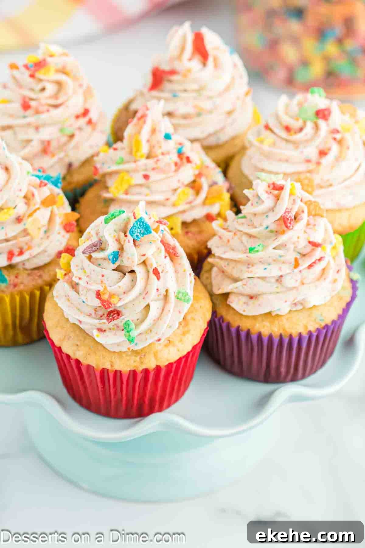 Fruity pebbles cupcakes on a platter. 